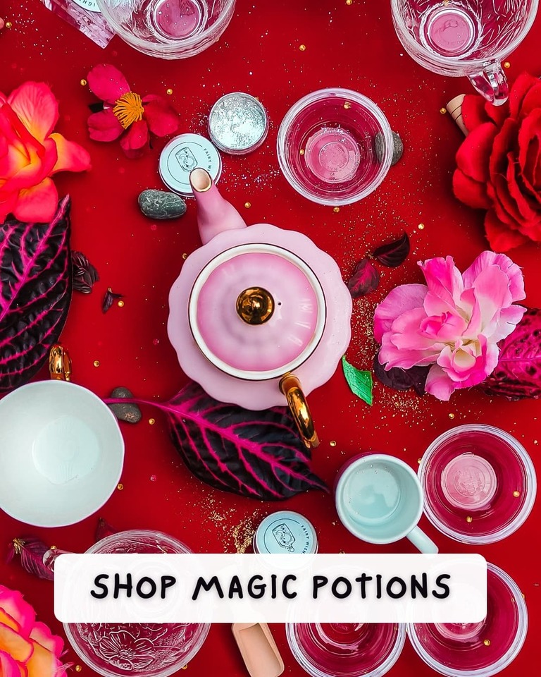 A gorgeous red table setting with magic potions from Sparkle & Spell Co.