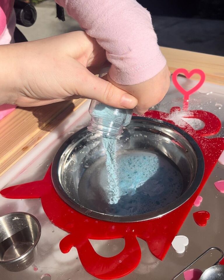 a mother helps her daugter pour magic potion into a stainless steel bowl